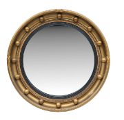 A Regency style gilt convex mirror