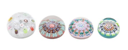 A collection of four millefiori glass paperweights,