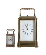 A brass carriage clock, with a repeater, and a miniature timepiece