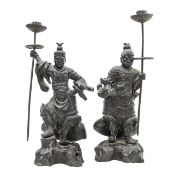 A pair of Japanese bronze figural candlesticks