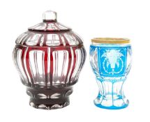 A Bohemian cranberry glass bowl and cover, and a blue cased glass vase