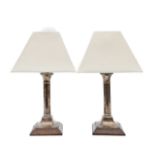 A pair of silver candlesticks, converted to lamps