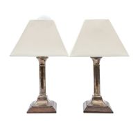 A pair of silver candlesticks, converted to lamps