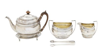 A George III silver four piece tea service and sugar tongs