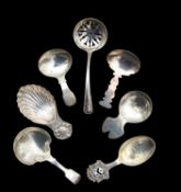 A group of six George III and later silver caddy spoons and a tea strainer