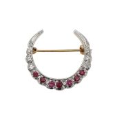 A diamond and ruby crescent moon brooch