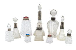 A collection of silver mounted and cut glass perfume bottles