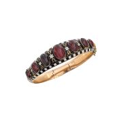 A Victorian enamel and garnet hinged bangle