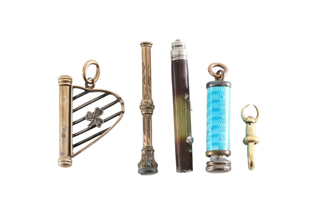 A collection of propelling pencils charms