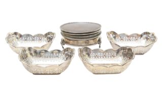 A George VI silver dressing table box, and four silver pierced dishes