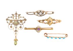 An Edwardian pendant and four brooches