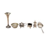 An Edward VII silver bud vase, tea strainer, and cruet set