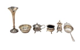 An Edward VII silver bud vase, tea strainer, and cruet set
