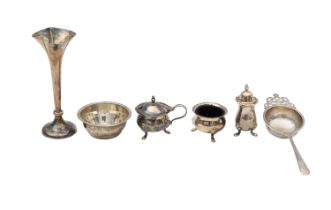An Edward VII silver bud vase, tea strainer, and cruet set