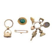 A small collection of gilt metal seals, brooches and pins