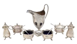 A George III silver cream jug, and a George V silver six piece cruet set