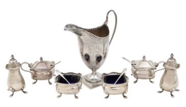 A George III silver cream jug, and a George V silver six piece cruet set