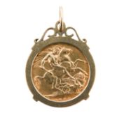 An Elizabeth II 1958 full sovereign gold coin in mount