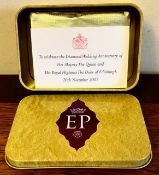 A PIECE OF FOIL WRAPPED, UNOPENED CAKE TO CELEBRATE THE DIAMOND WEDDING ANNIVERSARY OF HER LATE