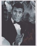 James Bond - George Lazenby - a signed 10x8 inch (approx.) photo, a classic casino scene from On Her