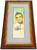 Robbie Williams signed 14x8 inch overall mounted and framed colour photo. Good condition. All