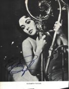 Elizabeth Taylor signed 6x5 inch black and white magazine photo. Good condition. All autographs come