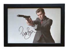 Pierce Brosnan signed 13x10inch overall framed James Bond colour photo. Good condition. All