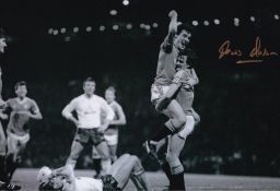 Autographed KEVIN MORAN 12 x 8 photo : B/W, depicting Frank Stapleton celebrating in the arms of