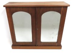 A mahogany cabinet with mirrored doors, 615mm wide