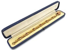 An early 20thC. cased 9ct gold bracelet set with a