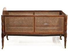 A late 19thC. walnut & cane cot, 975mm high x 1575