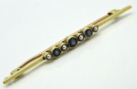 An antique 15ct gold bar brooch set with sapphire