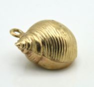 A 9ct gold charm in the form of a snail shell, 0.7g