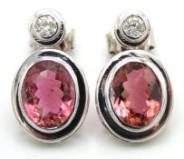 A pair of 18ct white gold earrings set with approx