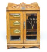 An oak Edwardian pip smokers cabinet with three dr