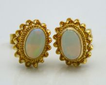 A pair of 9ct gold mounted opal earrings, 9.5mm at