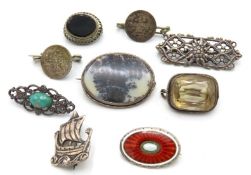 A selection of nine silver & white metal brooches