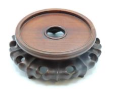 A 19thC. Chinese carved rosewood stand, to fit ves