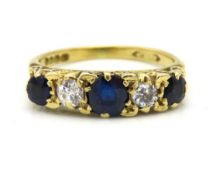 An antique yellow metal five stone ring with carve