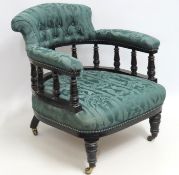 A Victorian upholstered tub chair with lacquered f