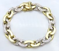 A 14ct two colour gold gents bracelet set with approx. 2.4ct of diamonds, 62g, 215mm long