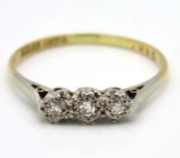 An antique 18ct gold ring set with three small dia