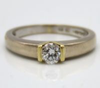 An 18ct two tone gold diamond solitaire ring set w