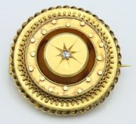 A Victorian yellow metal memorial brooch set with