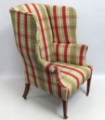 An early 19thC. upholstered wing back armchair, 11