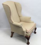 A Georgian wing back armchair with ball & claw fee
