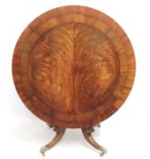A 19thC. flame mahogany circular tilt top dining t