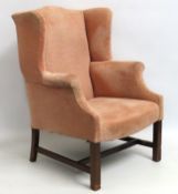 A 19thC. wing back armchair on walnut frame, 1005m