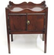 A Georgian mahogany bedside cabinet with elm inter