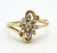 A 10ct gold ring of organic design set with seven